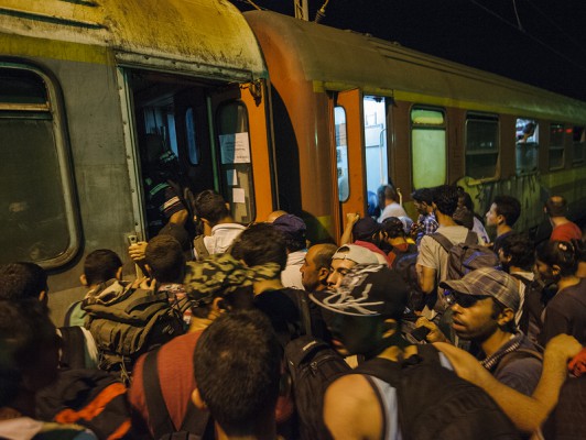 20150616 Tuesday 2249 A large group of migrants trying to enter the overcrowded train in Veles, Macedonia.