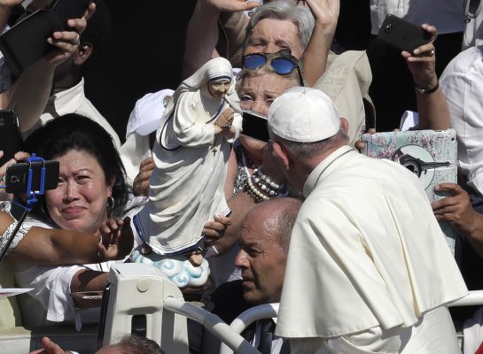 Pope Francis passes in front a statue of Mother Teresa as he is driven through the crowd at the end of a canonization ceremony in St. Peter's Square at the Vatican, Sunday, Sept. 4, 2016. Francis declared Mother Teresa a saint on Sunday, praising the tiny nun for having taken in society's most unwanted and for having shamed world leaders for the "crimes of poverty they themselves created." (AP Photo/Alessandra Tarantino)