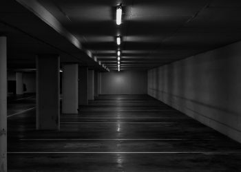 grayscale photo of hallway with lights
