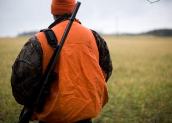 man in orange and black backpack