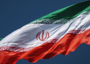 the flag of the country of iraq flying in the sky