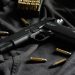 black semi automatic pistol on black textile