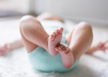 baby laying on bed