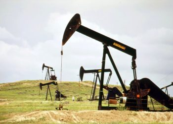 a group of oil pumps sitting on top of a field