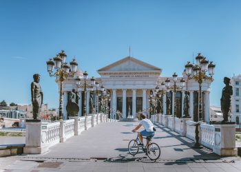 man on bike near building