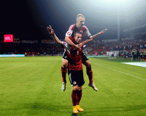 Ermir Lenjani (poshtë) duke festuar golin kundër Danimarkës në Elbasan Arena të shtunën. (AP Photo/Hektor Pustina)