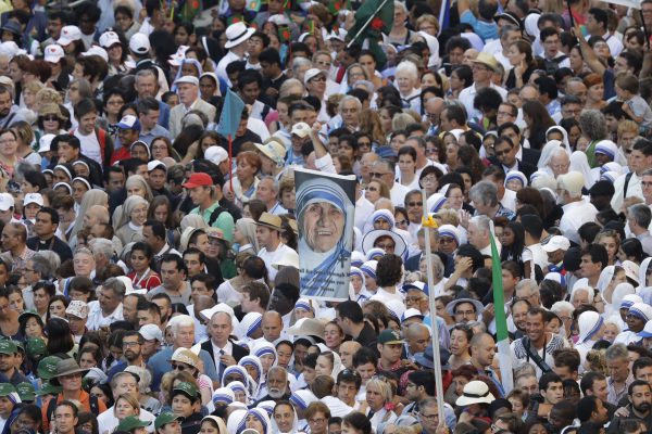 Faithful and pilgrims wait to enter in St. Peter's Square at the Vatican before a canonization ceremony, Sunday, Sept. 4, 2016. Thousands of pilgrims thronged to St. Peter's Square on Sunday for the canonization of Mother Teresa, the tiny nun who cared for the world's most unwanted and became the icon of a Catholic Church that goes to the peripheries to tend to lost, wounded souls. (AP Photo/Alessandra Tarantino)