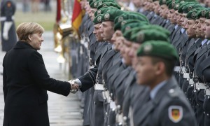 Germany Portugal German Chancellor Angela Merkel, left, shakes hands with a soldier of the honor guard prior to a military welcome ceremony for the Prime Minister of Portugal, Antonio Costa, as part of a meeting at the chancellery in Berlin, Germany, Friday, Feb. 5, 2016. (AP Photo/Michael Sohn)