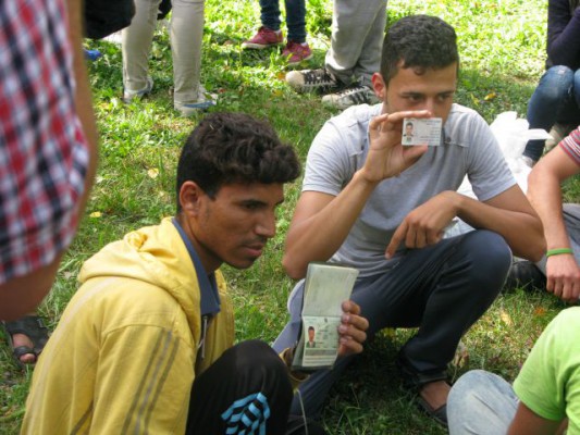 Syrian refugees showing their passports, going towards Germany.
