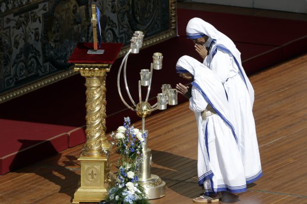 Sisters of the Missionaries of Charity pay their respects in front of the relics of Mother Teresa during her Canonization Mass celebrated by Pope Francis in St. Peter's Square, at the Vatican, Sunday, Sept. 4, 2016. Francis has declared Mother Teresa a saint, honoring the tiny nun who cared for the world's most destitute as an icon for a Catholic Church that goes to the peripheries to find poor, wounded souls. (AP Photo/Gregorio Borgia)