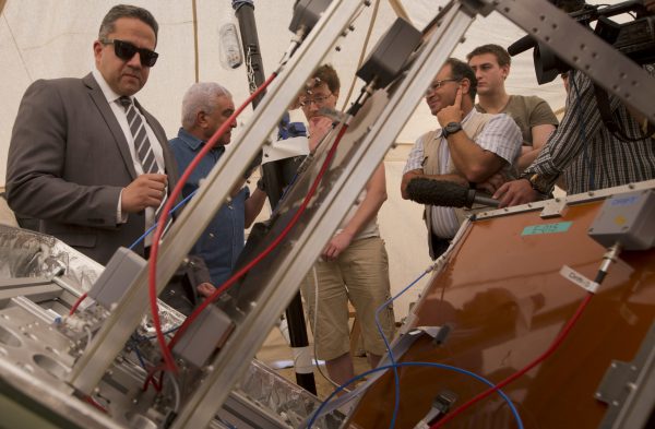 Egyptian Antiquities Minister, Khaled El-Anani, left, and Zahi Hawass, Egypt's former head of antiquities, second left, listen to French expert Sebastien Procureur in front of a muon detector machine in front of the Great Pyramid, built by Cheops, known locally as Khufu in Giza, Egypt, Thursday, June 2, 2016. A scientific team scanning the Great Pyramid aimed at discovering the famed pharaonic monument's secrets including possible hidden burial chambers. (AP Photo/Amr Nabil)