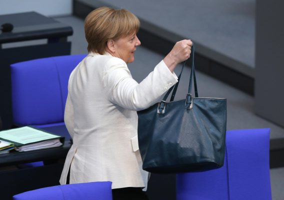 Kancelarja gjermane Angela Merkel mban çantën e saj teksa mbërrin në seancën e parlamentit gjerman më 7 korrik 2016. Foto: BETA/(Wolfgang Kumm)