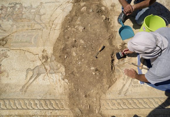 Archeologist work on a rare mosaic floor dating to the 4th century depicting scenes from a chariot race in the hippodrome, in Akaki village outside from capital Nicosia, Cyprus, on Wednesday, Aug. 10, 2016. The 4th century mosaic rare is the only one of its kind in Cyprus and one of only handful in the world. (AP Photo/Pavlos Vrionides)