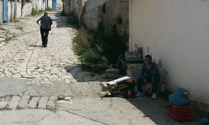 Një tregtar në Berat duke tregtuar fshehurazi duhan të hapur më 30 prill 2015. Një numër i madh shqiptarësh po konsumon duhan të dredhur duke reduktuar importet e taksueshme dhe duke rrënuar të ardhurat e qeverisë. Foto: BIRN